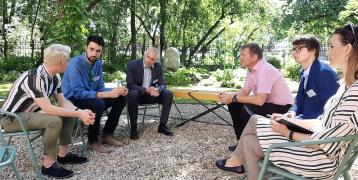 six people talking in a garden six people talking in a garden