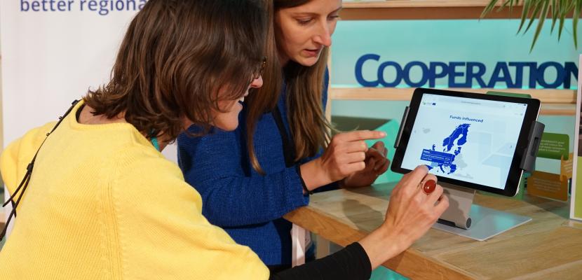 women showing information on a tablet One woman showing to another woman showing a webpage about European funds on a tablet