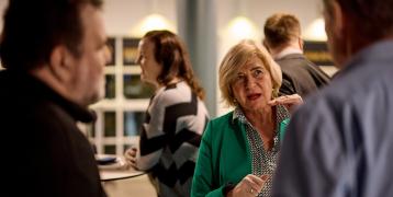 Older woman talking to two men Older woman talking to two men