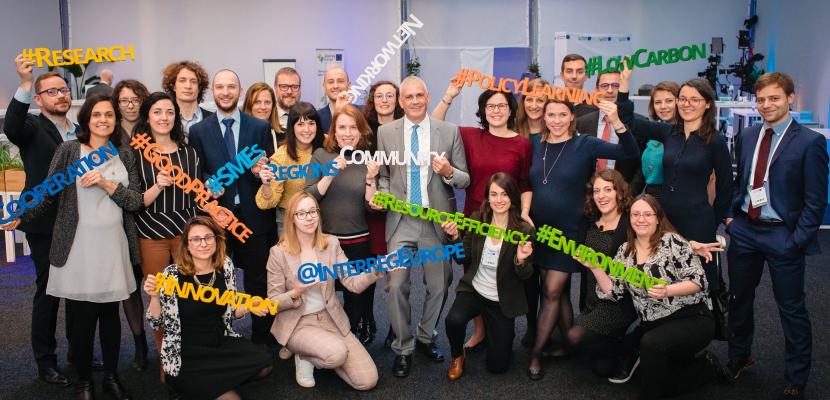 Joint secretariat team photo at Europe, let's cooperate Joint secretariat staff posing for team photo holding wooden hashtags