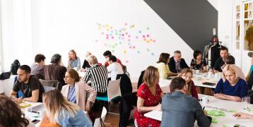 People working in groups on post-its People working in groups on post-its