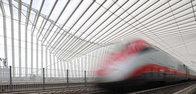 Blurry fast moving train through station Blurry fast moving train through station