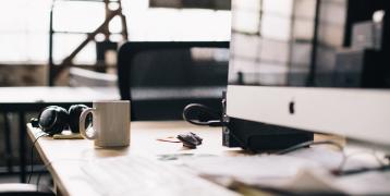 Desk with a computer and a mug Desk with a computer and a mug