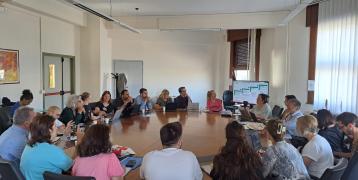 SALAM in tuscany People sit in a room around a large table